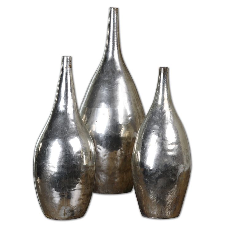 three silver vases sitting on top of a wooden table