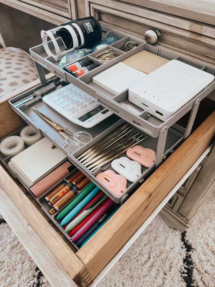 an organized drawer is shown with many items in it and on top of the drawers