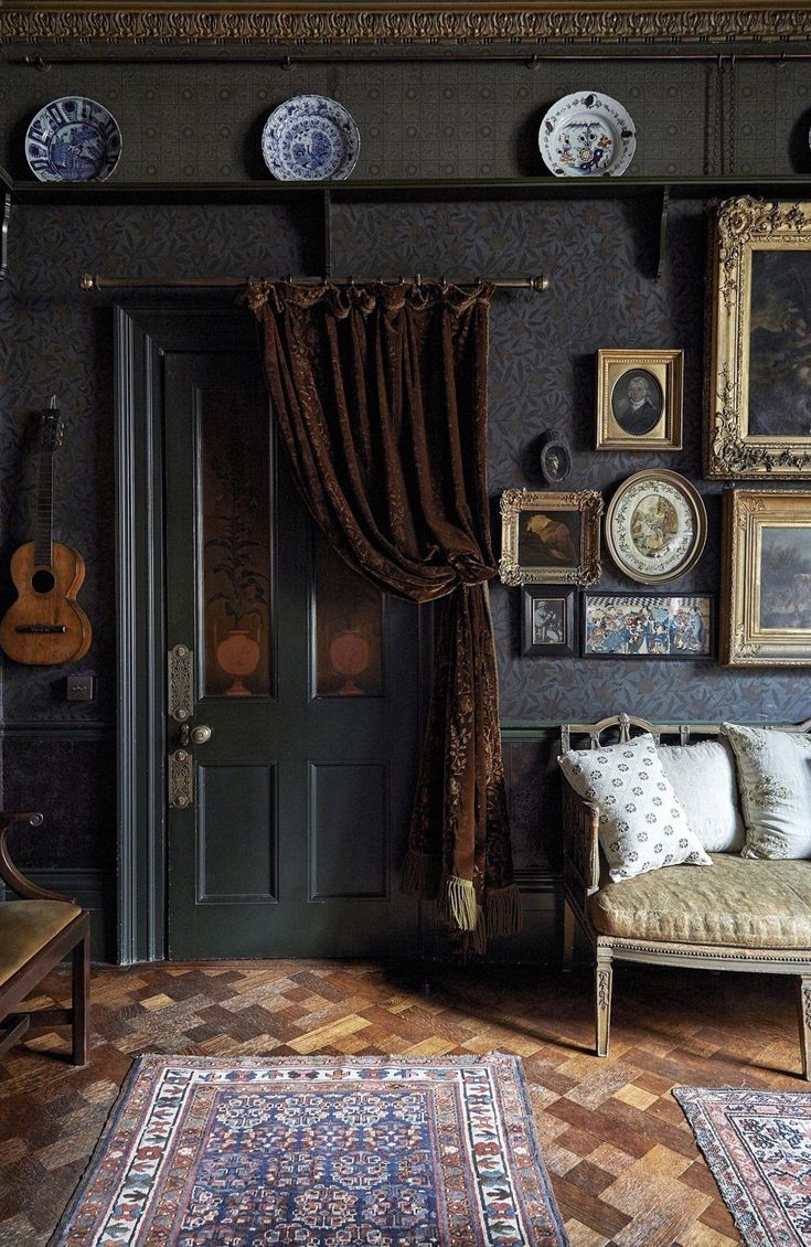 a living room filled with lots of furniture and pictures on the wall next to a doorway