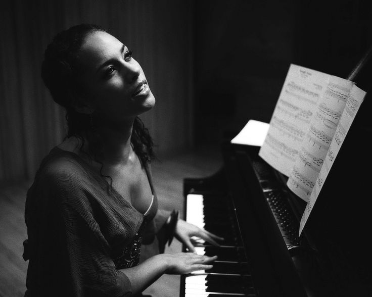 a woman sitting at a piano with sheet music