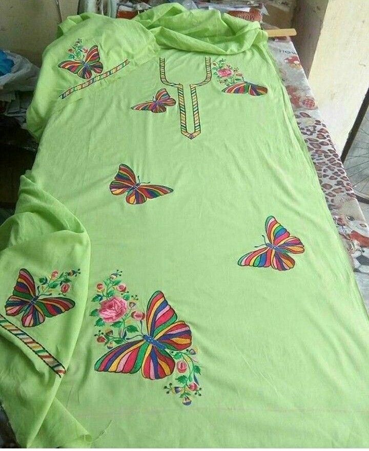 a green shirt with colorful butterflies on it is displayed in an instagramtion photo