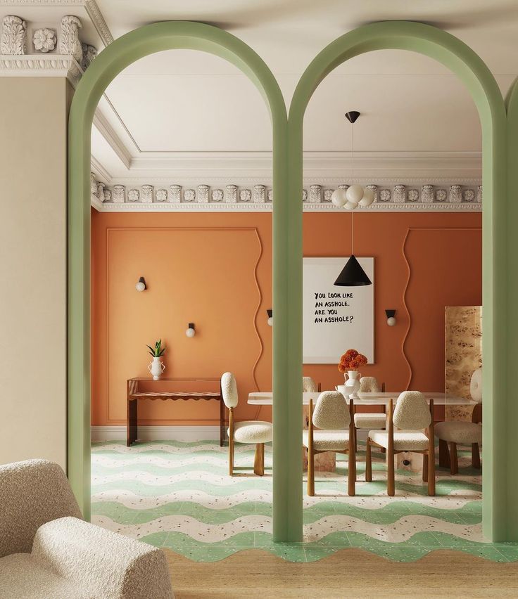 an orange dining room with white chairs and green arches on the wall, in front of a large window