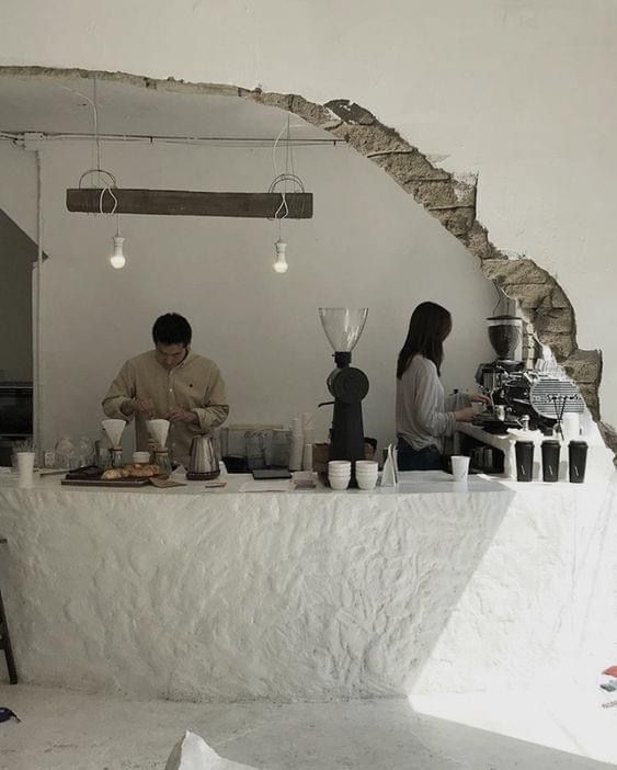 two people sitting at a table with food on it