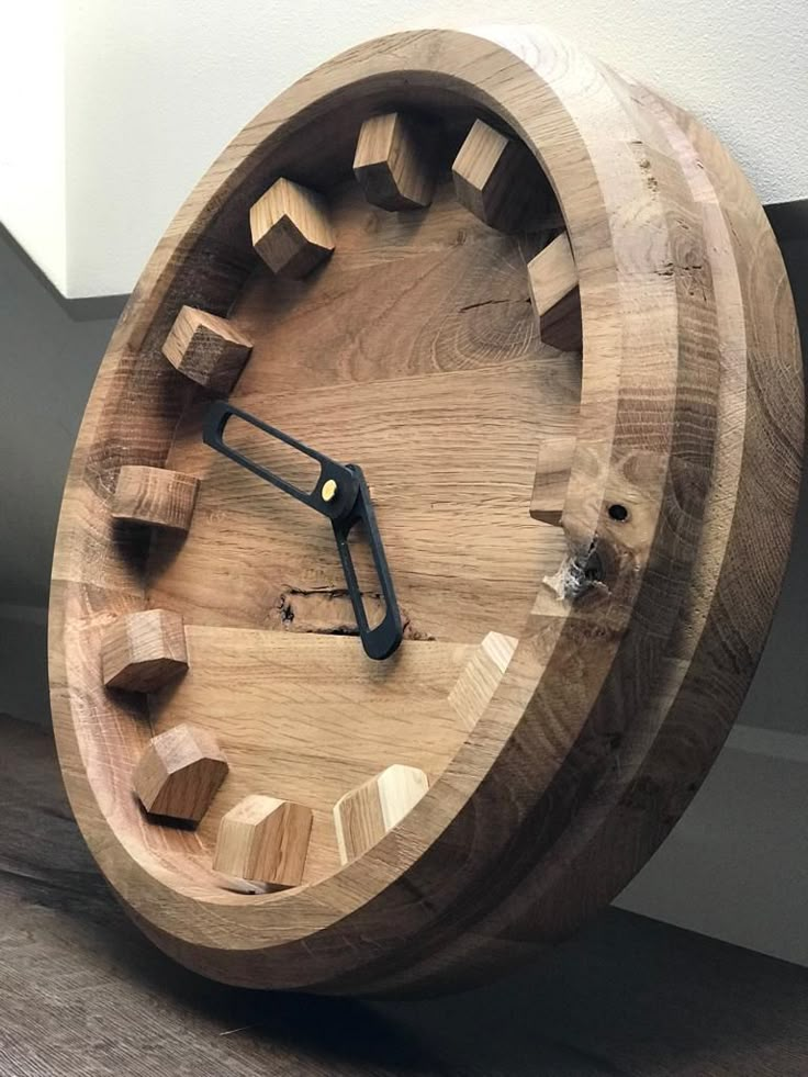 a clock made out of wooden blocks on the floor