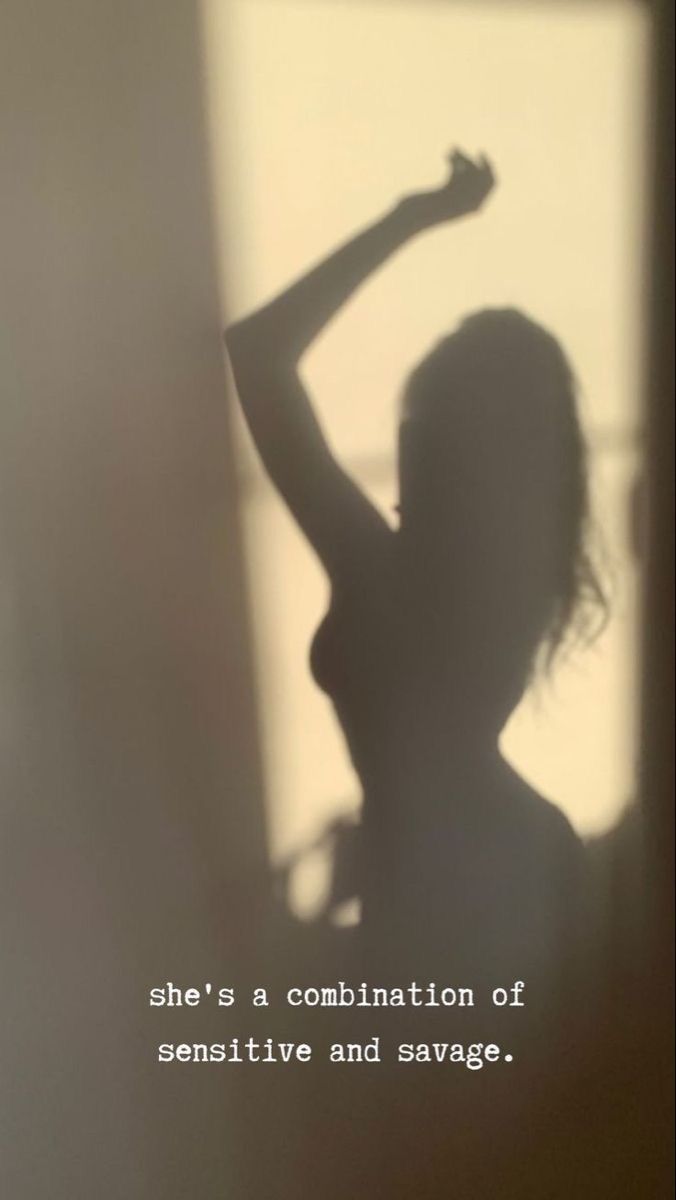 the shadow of a woman's body is shown in front of a white wall