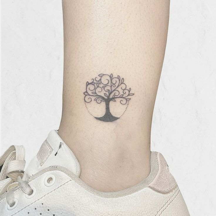 a small tree tattoo on the ankle