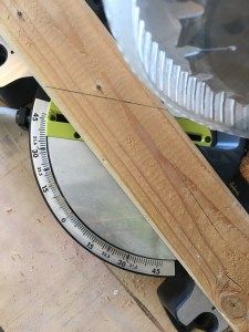 a circular wooden ruler sitting on top of a piece of wood