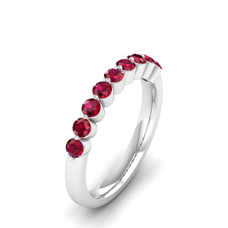 a white gold ring with red stones