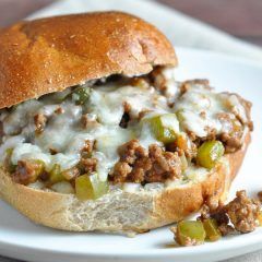 a close up of a sandwich on a plate with meat and cheese in the middle