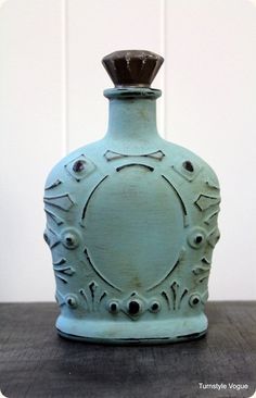 an old blue bottle sitting on top of a wooden table