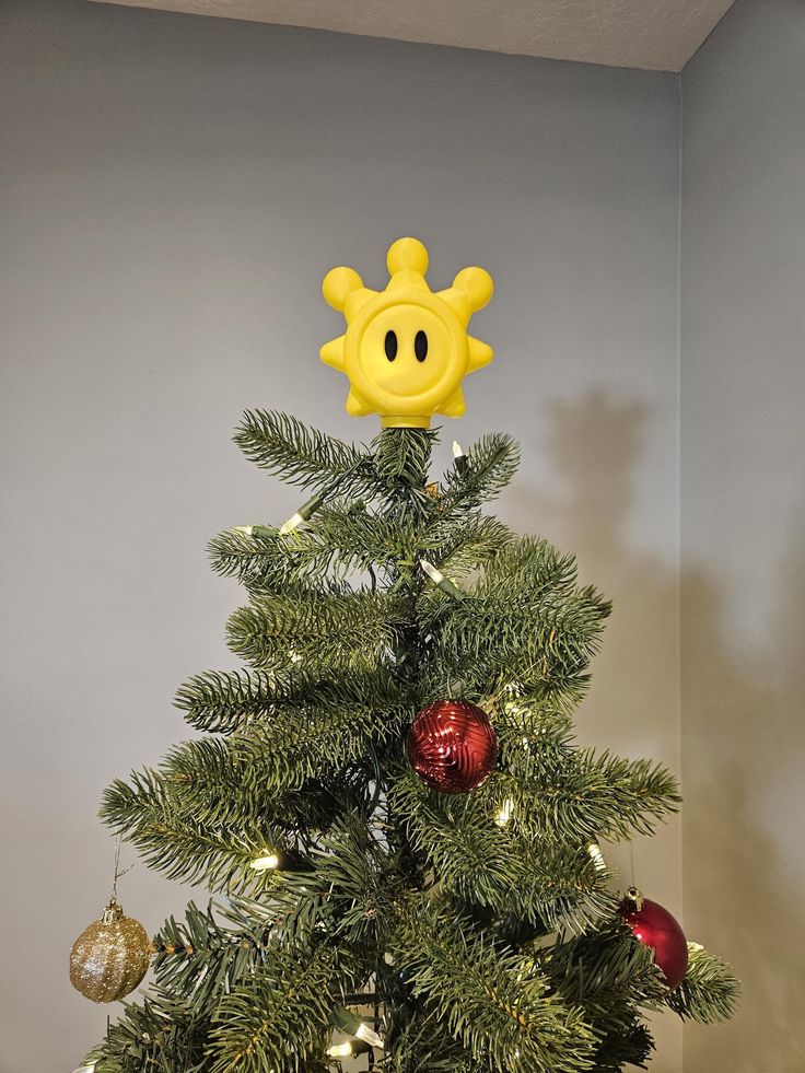 a christmas tree with a smiley face on top