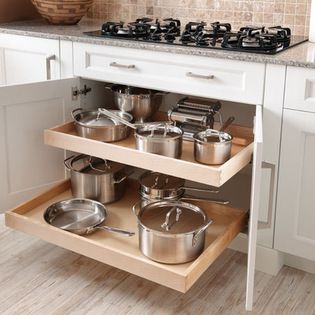 an open cabinet with pots and pans on it