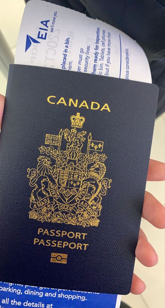 a canadian passport being held in someone's hand