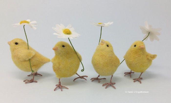 five little yellow chicks with daisies in their beaks, all facing different directions