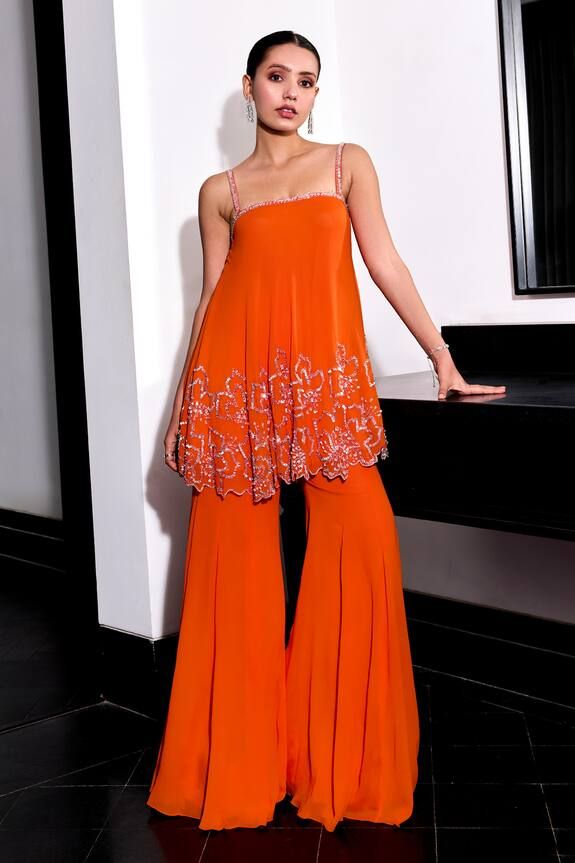 Orange top with glass bead, sequin, cutdana embroidery in floral pattern. Paired with bell bottom pant. - Aza Fashions Indian Sequin Dress, Sequin Indian Outfit, Top Embroidery Designs, Haldi Suit, Indo Western Outfits For Women, Floral Embroidery Top, Cutdana Embroidery, Trendy Outfits Indian, Bell Pants