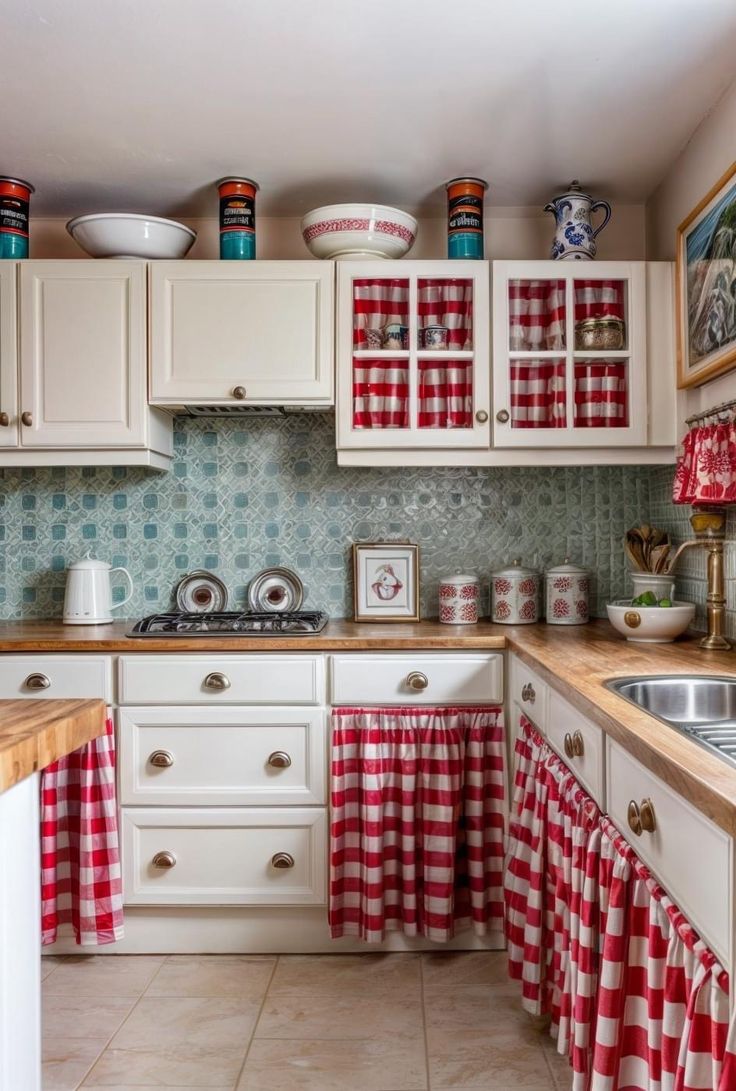 a kitchen with white cabinets and red checkered curtains