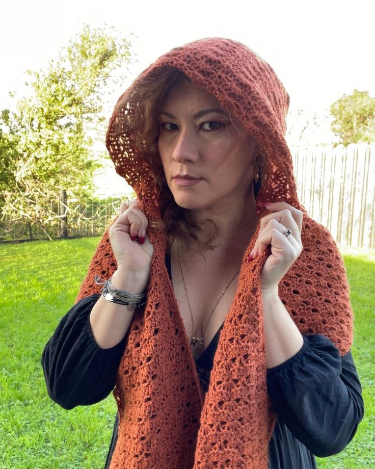 a woman wearing an orange crocheted scarf