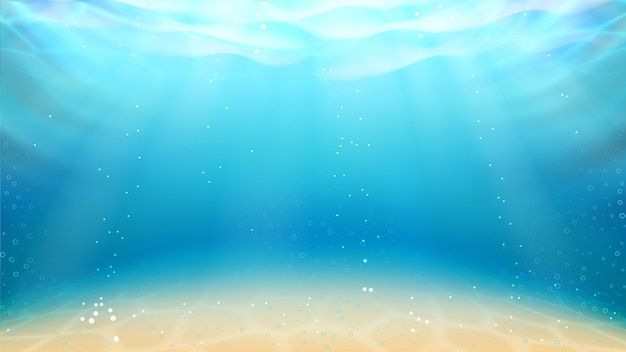 an underwater scene with blue water and sunbeams in the sky, as well as sand