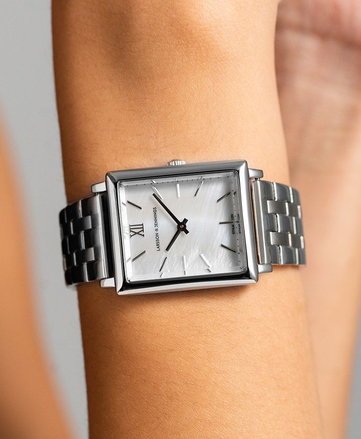 An iconic design, elevated. Combining the classic style of old vintage watches with an ultra-modern appeal in striking silver. The large square-shaped 40mm dial features roman numerals and an elegant mother of pearl dial making it an eye-catching and versatile timepiece. Boyfriend pairs classic design with robust sterling silver links for an effortless yet captivating piece. Square Faces, Ultra Modern, Stylish Watches, Iconic Design, Square Watch, Old Vintage, Roman Numerals, Watches Jewelry, Silver Watch