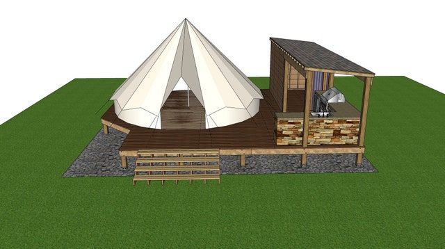 a small building with a large white tent on top of it