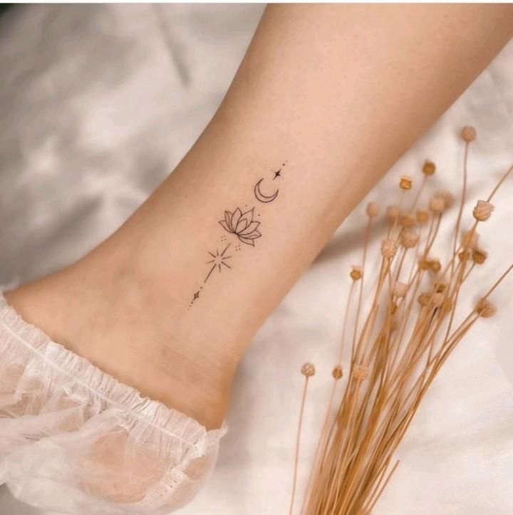 a woman's foot with a small tattoo on it