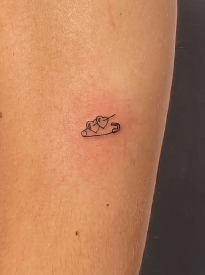 a person with a small tattoo on their arm