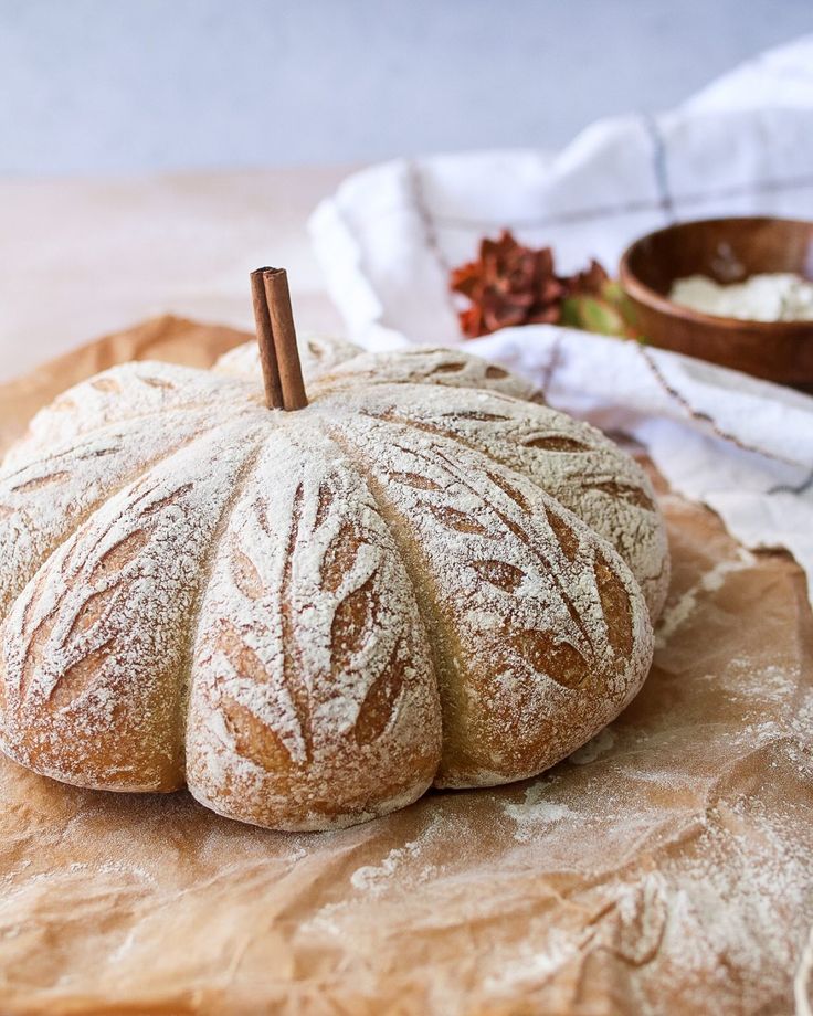 a loaf of bread sitting on top of a wooden cutting board