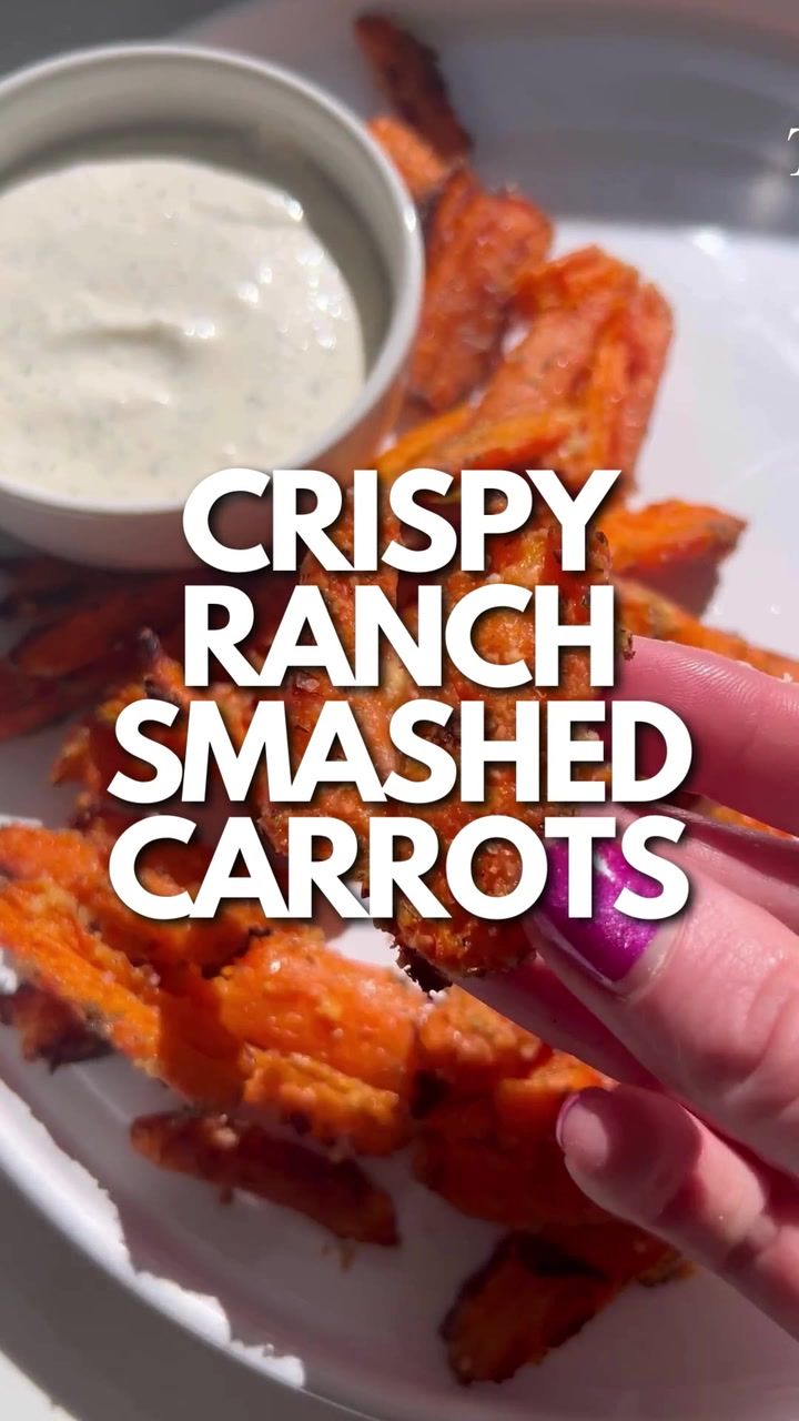 crispy ranch smashed carrots on a white plate with dipping sauce in the background