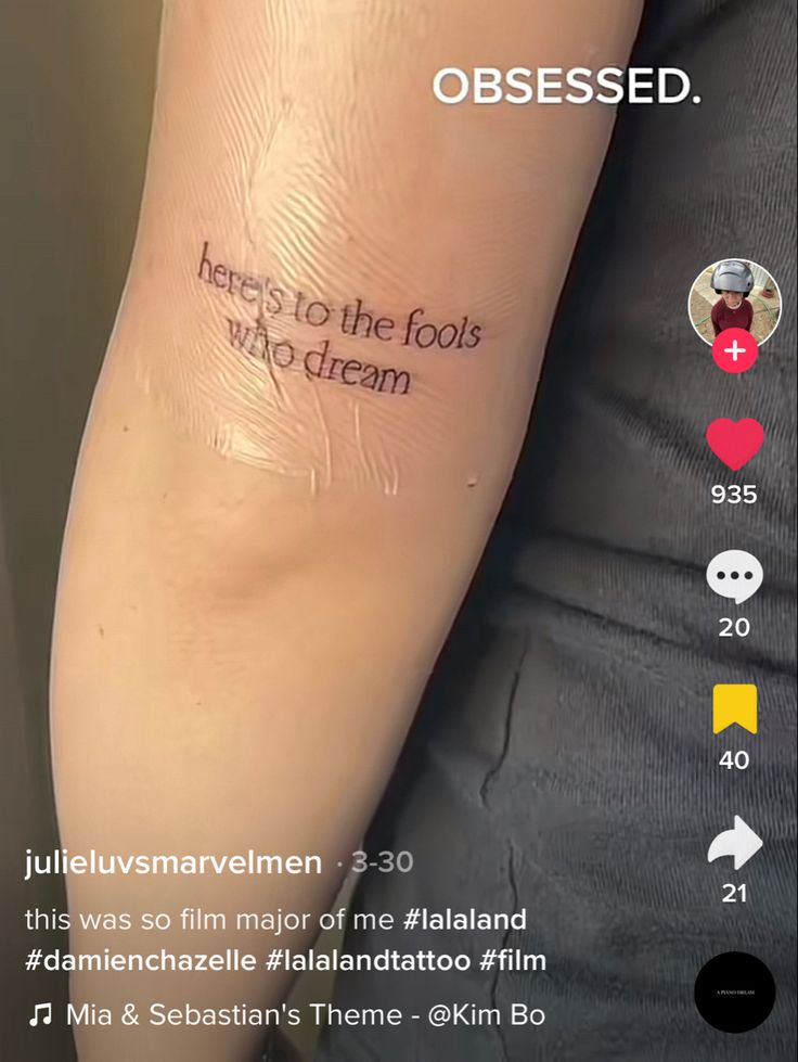 a person with a tattoo on their arm that says, here is to the tools who dream