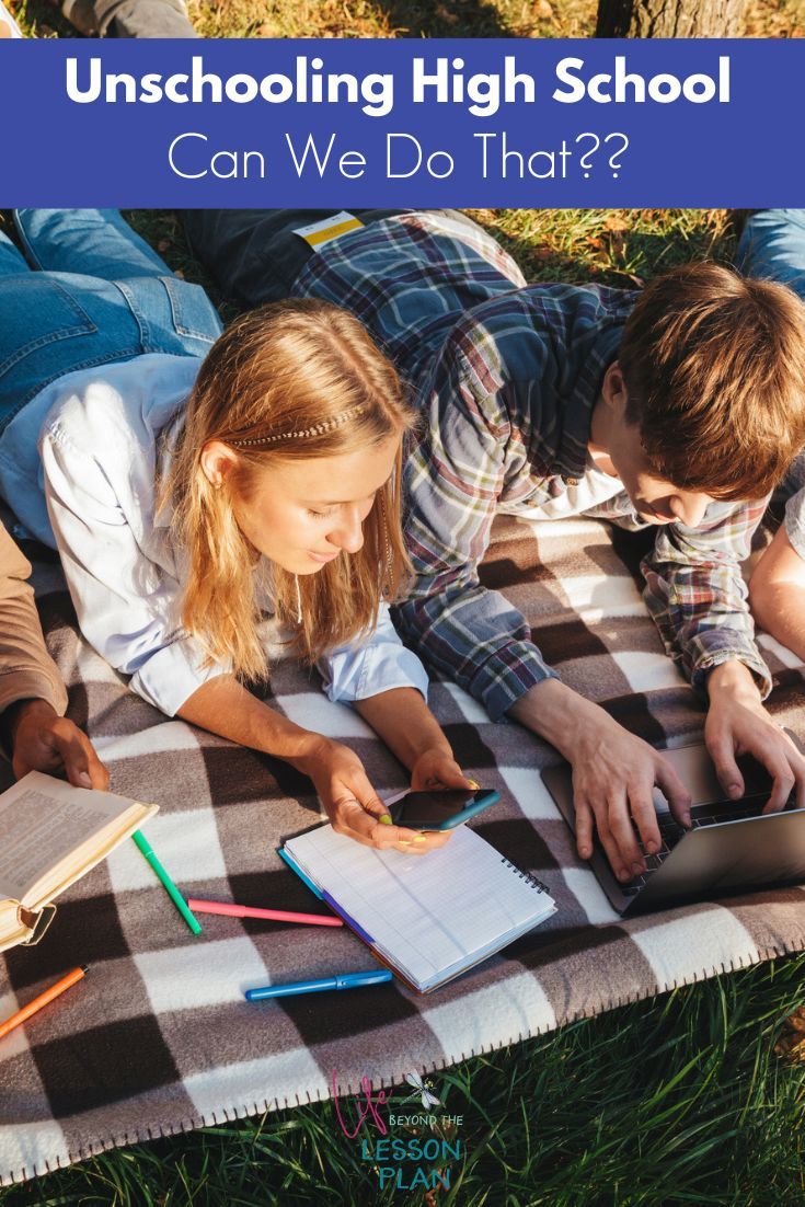 two children are laying on the grass with books and notebooks in front of them text reads unschooling high school can we do that?