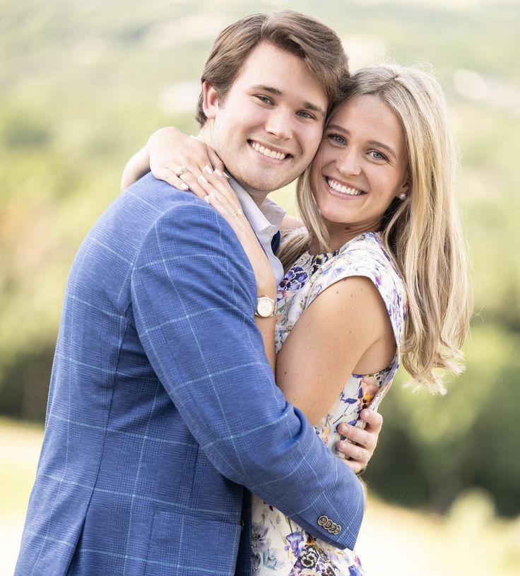 a young man and woman hugging each other