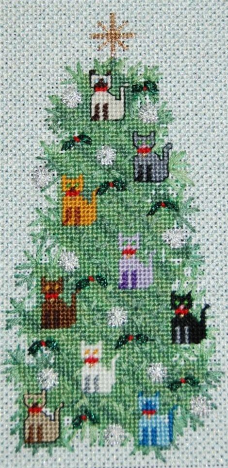 a cross stitch christmas tree with cats on it