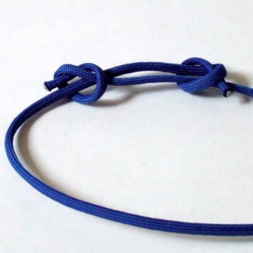 a close up of a blue rope on a white surface