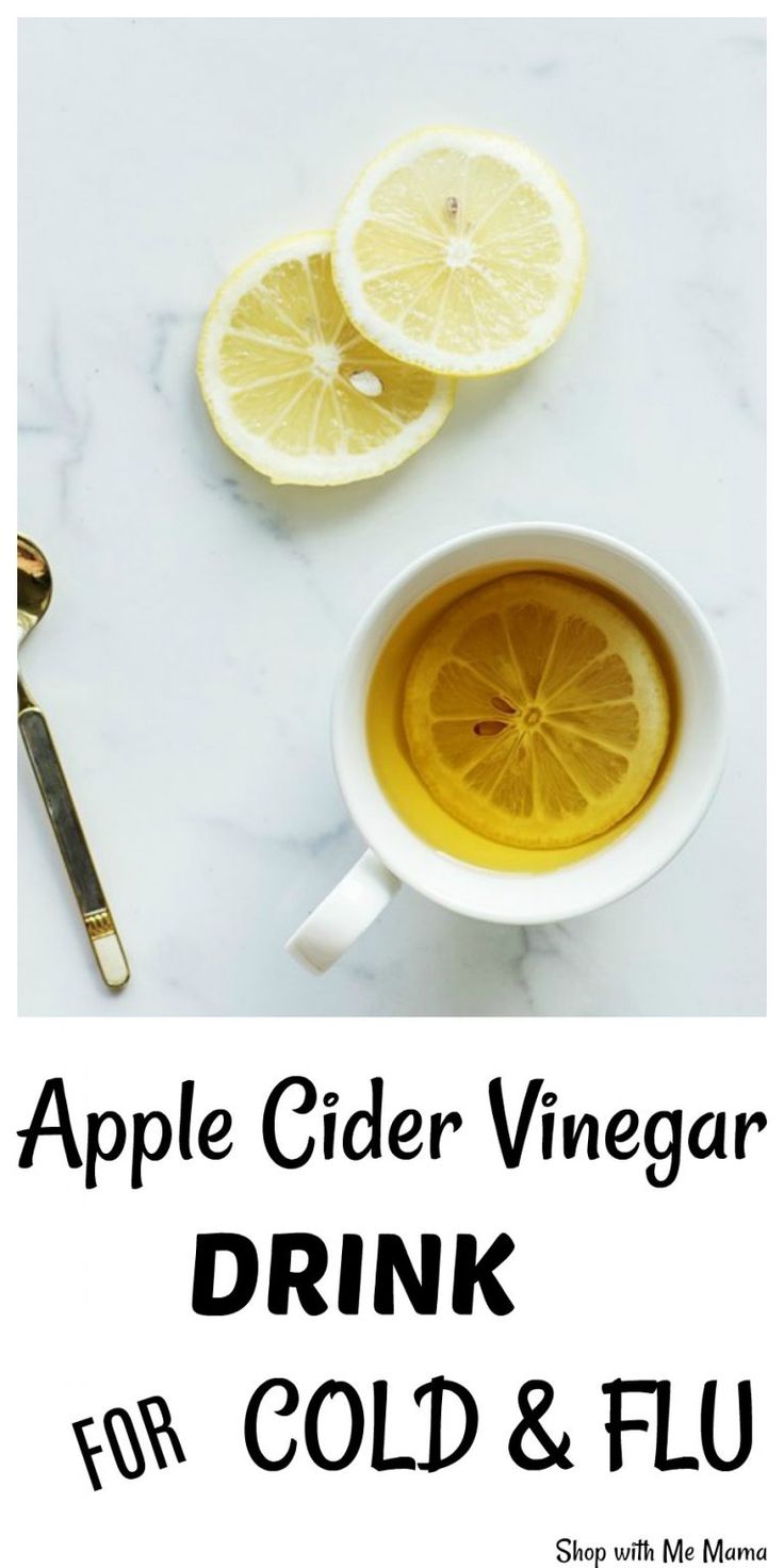 an apple cider vinegar drink for cold and fluff with lemon slices on the side