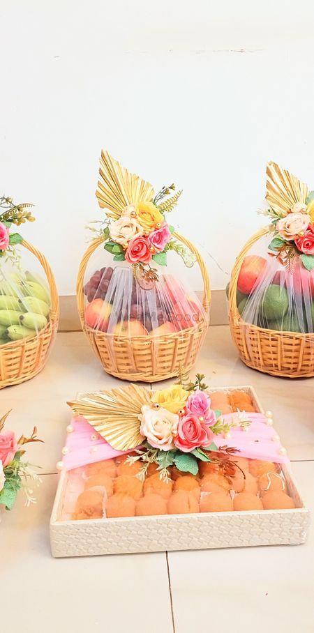 four baskets filled with fruit sitting on top of a white floor next to each other