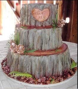 a three tiered wedding cake decorated with wood and pineconi, is displayed on a table