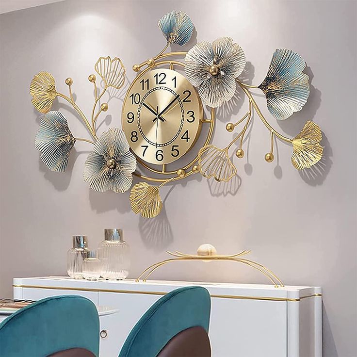 a wall clock that is on the side of a table with two chairs in front of it