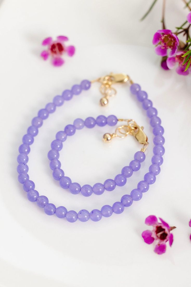 An ideal smooth shade of royal purple infused with blue undertones that emanates elegance and allure. The perfect accessory for every mom + her mini! Made with the highest quality materials, this bracelet will look beautiful for years to come. Durable enough for play, precious enough to keep forever. Materials: 14k gold filled or sterling silver components. Nickel free. To learn more about our materials and what makes gold filled unique read here. Features: Each bracelet has a ½” extender chain Elegant Purple Beaded Bracelets For Gift, Elegant Purple Beaded Bracelets As Gift, Elegant Hypoallergenic Purple Beaded Bracelets, Elegant Purple Beaded Bracelet For Gift, Elegant Beaded Lavender Bracelets, Elegant Purple Beaded Bracelet Gift, Elegant Lavender Beaded Bracelets, Elegant Lavender Beaded Bracelet, Adjustable Purple Bracelets For Formal Occasions