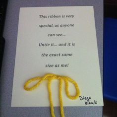 a piece of paper that has some type of yellow string attached to it with a thread