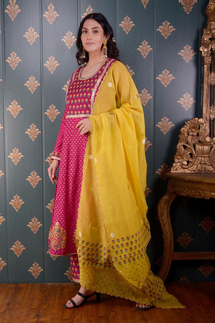 Magenta anarkali with floral foil print and lace trim on the neckline and sleeve hems. Comes with straight pants and mustard yellow chanderi dupatta.
Component: 3
Pattern: Print and Embroidery
Type Of Work: Foil Print, Sequin and Thread
Neckline: Round
Sleeve Type: Full
Fabric: Anarkali: Banarasi Chanderi, Pant: Cotton Satin and Dupatta: Chanderi
Color: Magenta
Other Details: 
Floral print dupatta with scalloped border
Lace trim on the neckline, bodice and sleeve hem
Occasion: Puja - Aza Fashion Magenta Anarkali, Chanderi Anarkali, Chanderi Dupatta, Border Lace, Scalloped Border, Color Magenta, Foil Print, Straight Pants, Set For Women