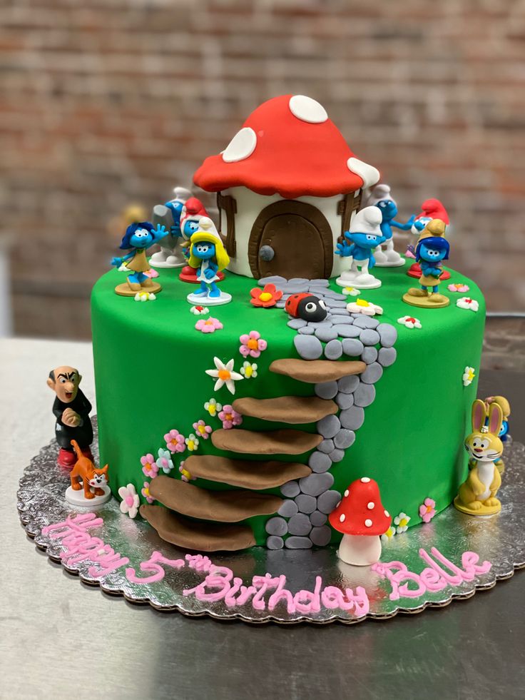 a birthday cake decorated with an image of a mushroom house