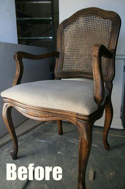 an old chair is upholstered with white fabric and has been refinished