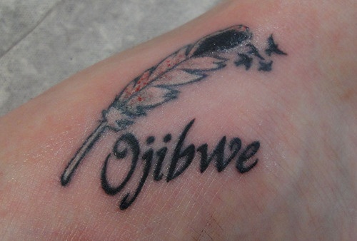 a person with a tattoo on their foot that has the word ophive written in cursive writing