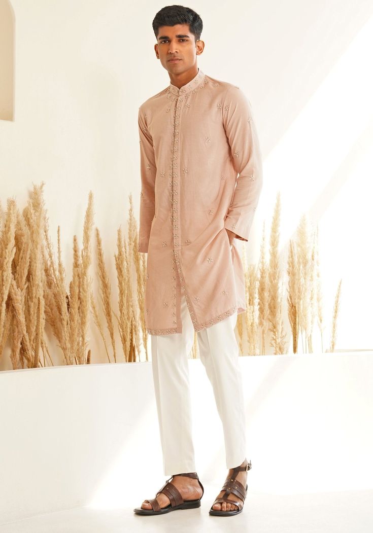 Introducing a modern Pastel Pink Kurta Set, featuring a sleek Chinese collar, hidden placket, and exquisite hand-embroidered detailing in muted hues. Paired with trendy white pants, this ensemble is perfect for an engagement, Roka or Mehendi, combining contemporary style with traditional elegance. Composition : Chanderi Silk Care: Dry Clean Only and Vacuum Storage This product can be customized for sleeves, length and colour Delivery : 4-6 weeks as the product is hand crafted. Check Size Guide or choose MySize for free customisation (All Sizes above XL can be made at 15% additional cost) For more information and sizes please contact fabiliciousfashion@gmail.com or visit our Copenhagen studio. About the Designer : Shreyansh, a distinguished designer label specializing in luxurious ethnic me Elegant Cotton Traditional Wear With Floral Embroidery, Elegant Cotton Silk Bandhgala For Diwali, Elegant Cotton Sets For Designer Wear, Spring Wedding Cotton Sherwani, Elegant Cotton Silk Sherwani With Resham Embroidery, Elegant Cotton Traditional Wear With Resham Embroidery, Elegant Traditional Cotton Wear With Resham Embroidery, Elegant Cotton Silk Bandhgala With Resham Embroidery, Elegant Cotton Sherwani For Wedding