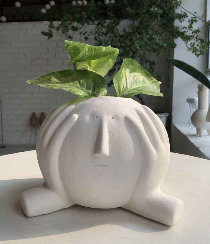 a white planter sitting on top of a table