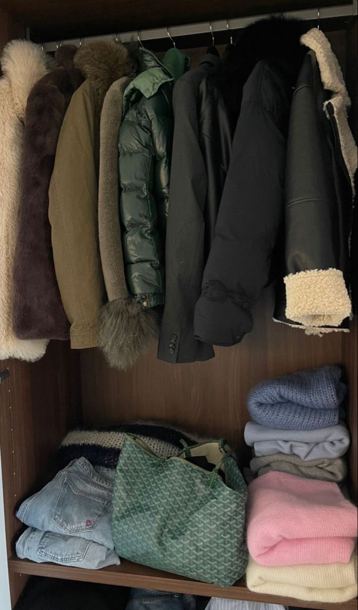 a closet filled with lots of clothes and coats