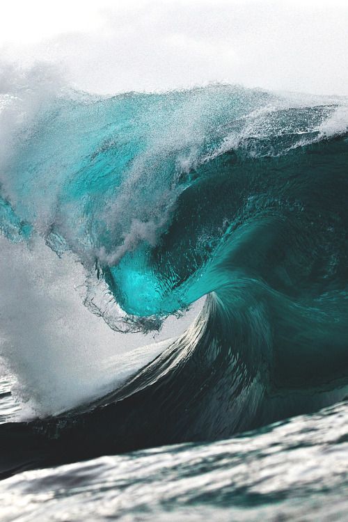 an ocean wave is breaking into the water