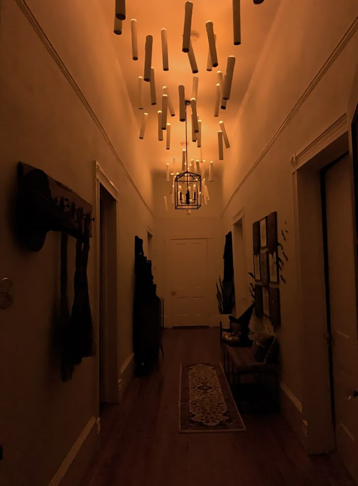 an empty hallway with lights hanging from the ceiling