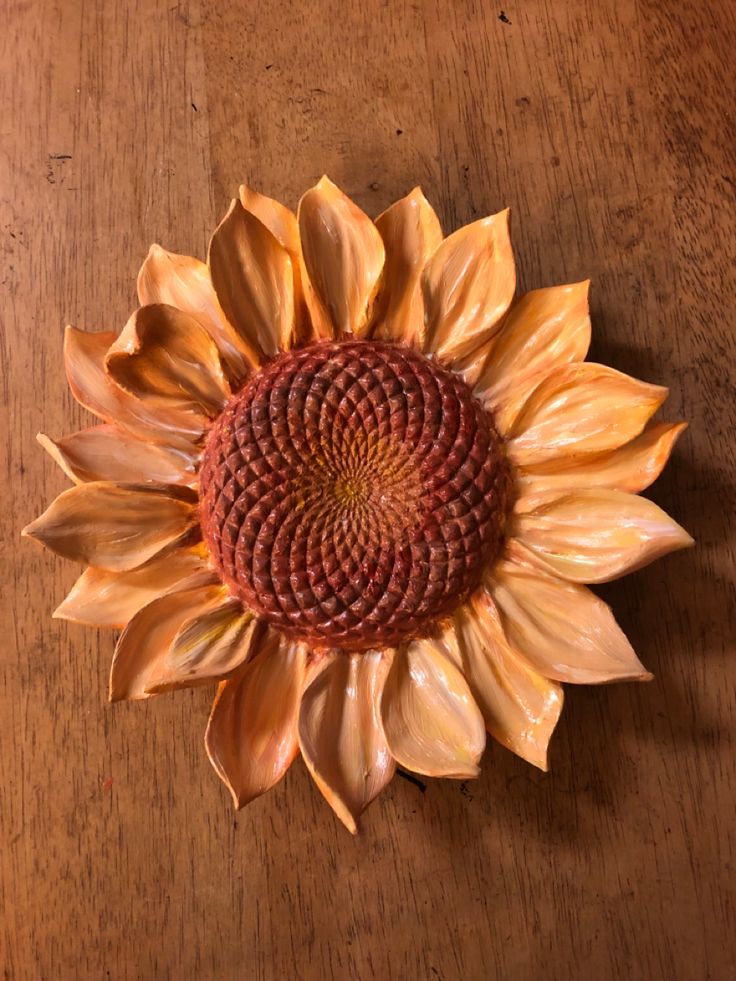 a large sunflower sitting on top of a wooden table