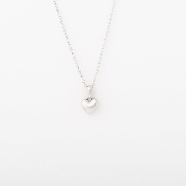 The Heart Necklace is the perfect piece for all of the loves in your life. Solid 14k gold heart pendant. Offered on an adjustable 16-18" chain or a 20" chain. Dimensions: 7mm Classic Heart-shaped Sterling Silver Necklace, Elegant Heart Pendant Necklace With Box Chain, Classic Round Pendant Necklace For Valentine's Day, Valentine's Day Heart Pendant Necklace With Box Chain, Valentine's Day Heart Necklace With Box Chain, White Gold Heart Pendant Jewelry With Box Chain, Delicate White Gold Heart Pendant Necklace, Delicate White Gold Necklace With Heart Charm, Classic Charm Necklace With Heart Pendant And Adjustable Chain